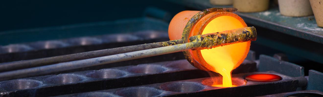 Molten metal being poured into molds