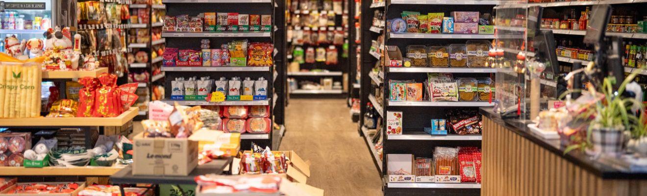 The image shows store shelves stocked with non-perishable food products.