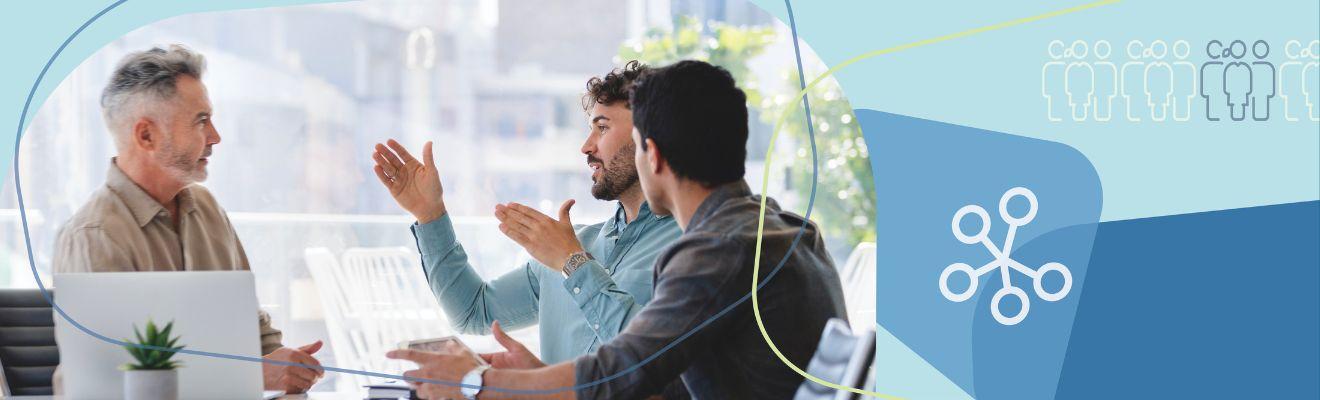 Decorative banner image of a diverse group of workers sitting around a table for a meeting.