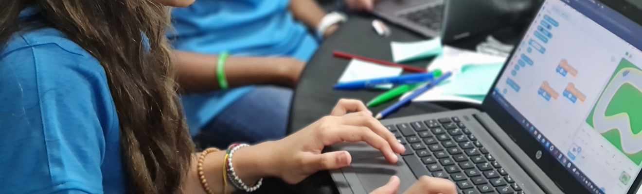 Class of First Nations students with a teacher working on laptops