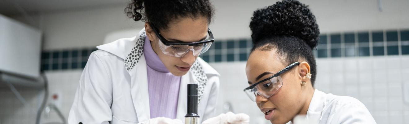 Teenage student using the microscope in the laboratory