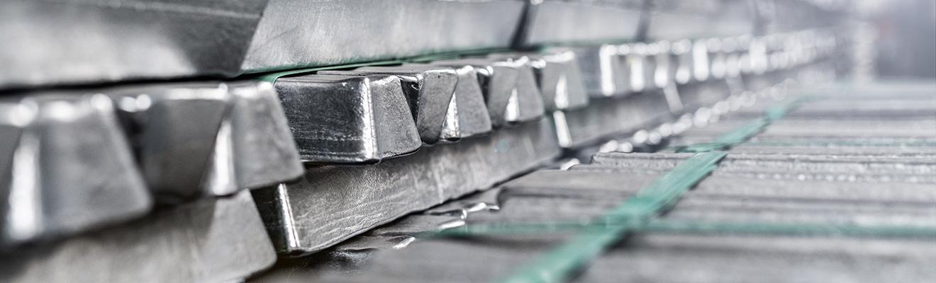 A closeup photo of stacked aluminium ingots.