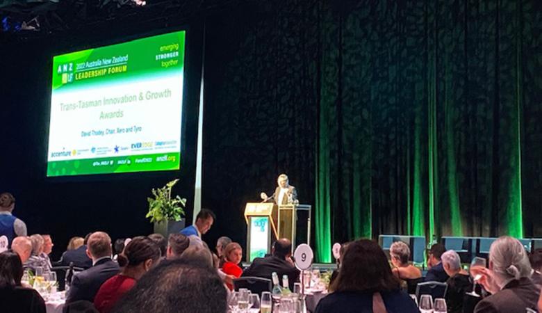 An awards recipient giving a speech on stage. 