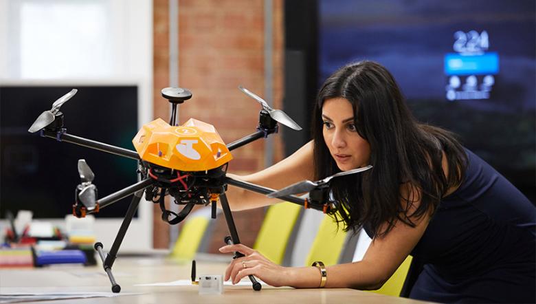 A Telstra employee examines one of Telstra’s drones