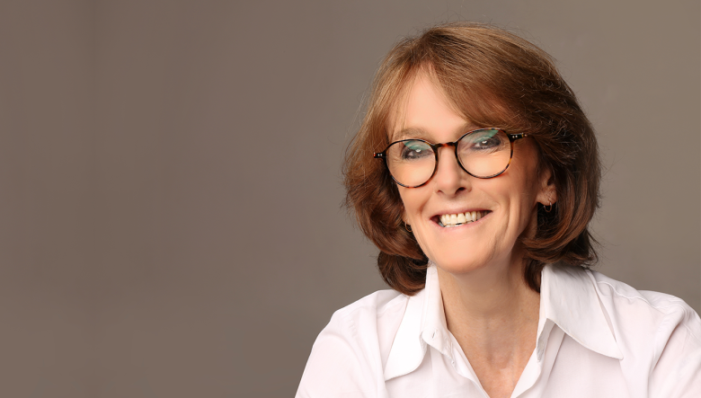 Woman wearing glasses smiling at camera