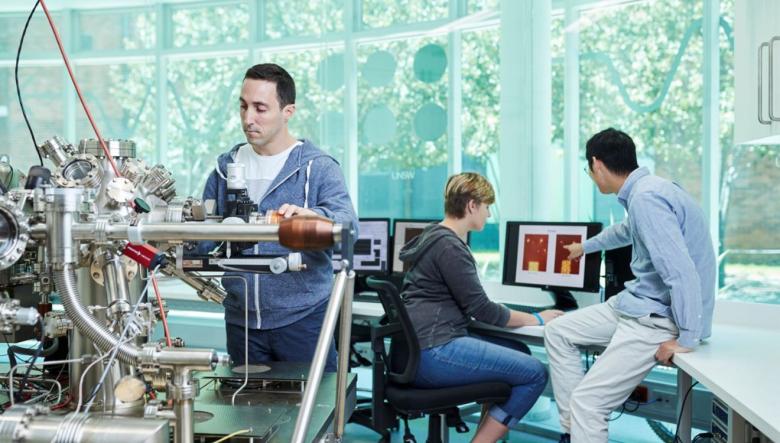 Photos shows a quantum technician working on equipment in a lab.