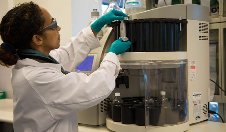 Photo of a technician in a laboratory testing a sample