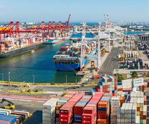 Photo of cargo containers, docked at a shipping yard