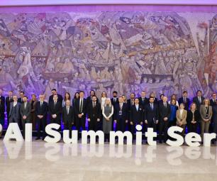 A group photo of representatives, standing behind large letters that spell out ‘GPAI Summit Serbia’.  