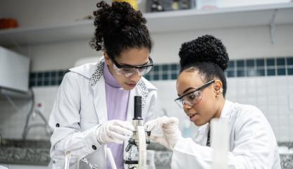 Teenage student using the microscope in the laboratory