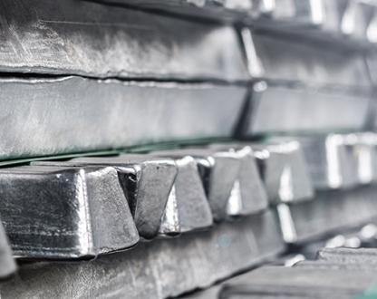 A closeup photo of stacked aluminium ingots.