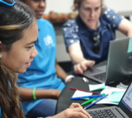 Class of First Nations students with a teacher working on laptops